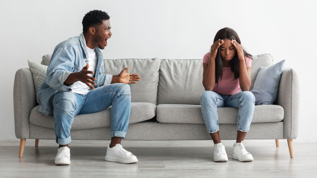 Young married black couple having fight, man yelling at woman